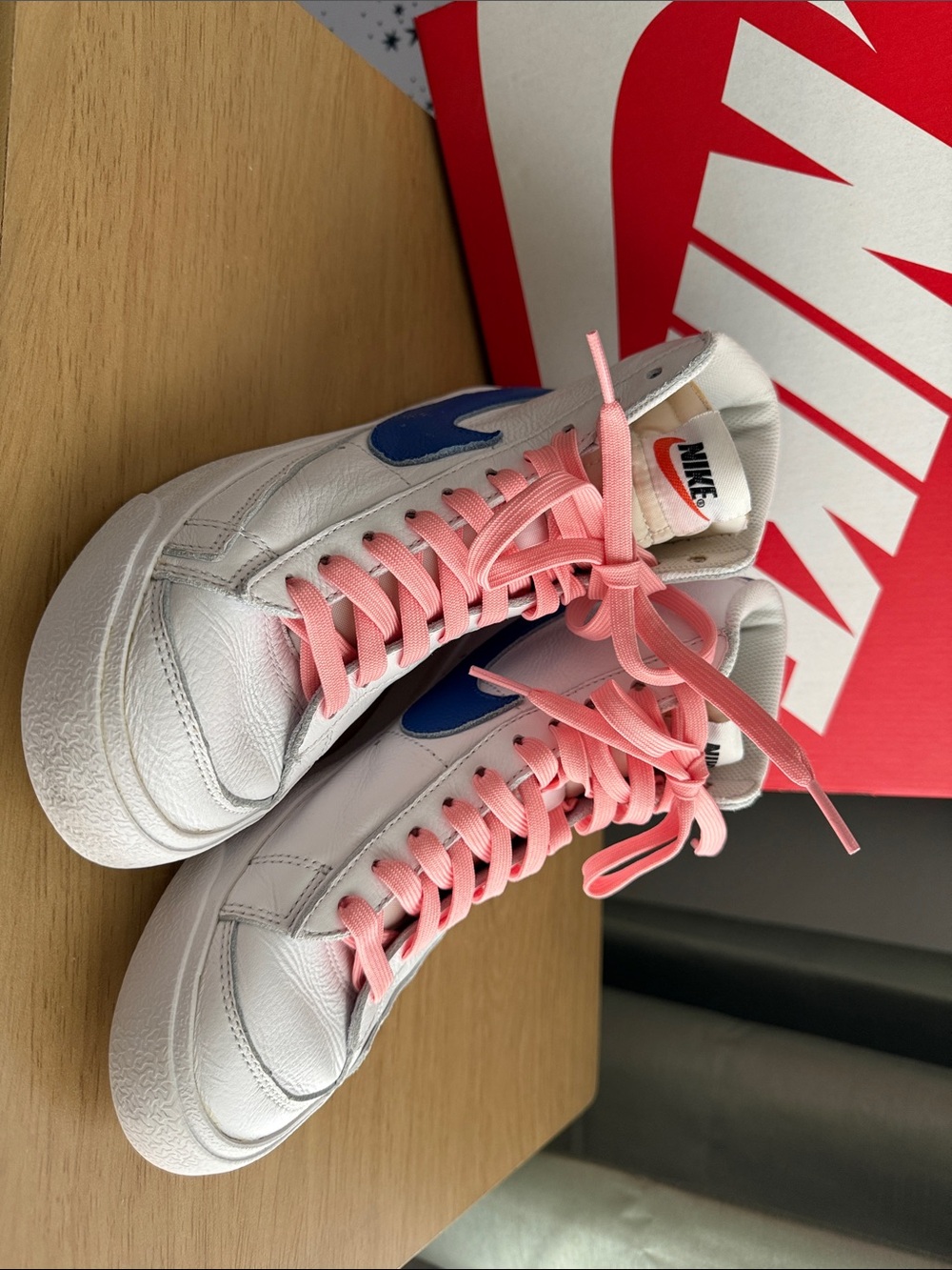 Nike White High-Top Sneakers with Pink Laces and Blue Swoosh